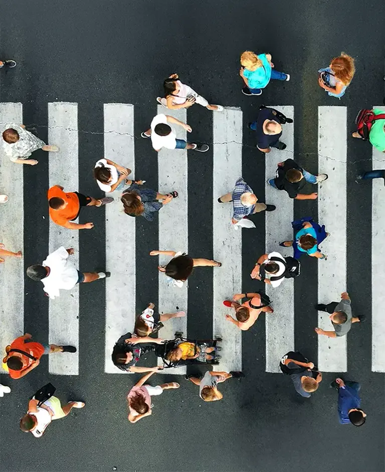 People crossing a pedestrian crosswalk viewed from above