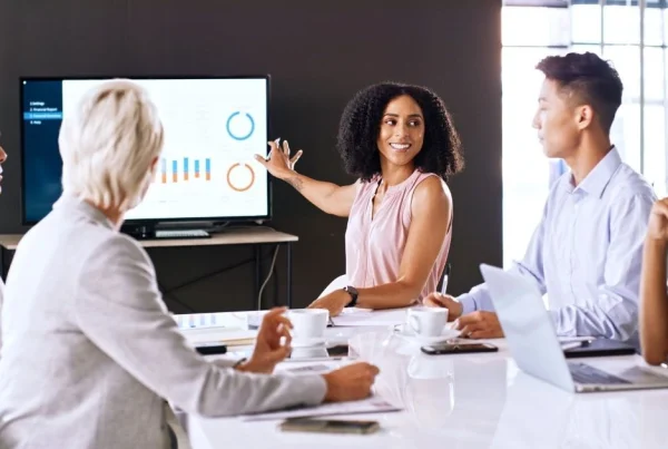 Business professional presenting charts to colleagues during a team meeting