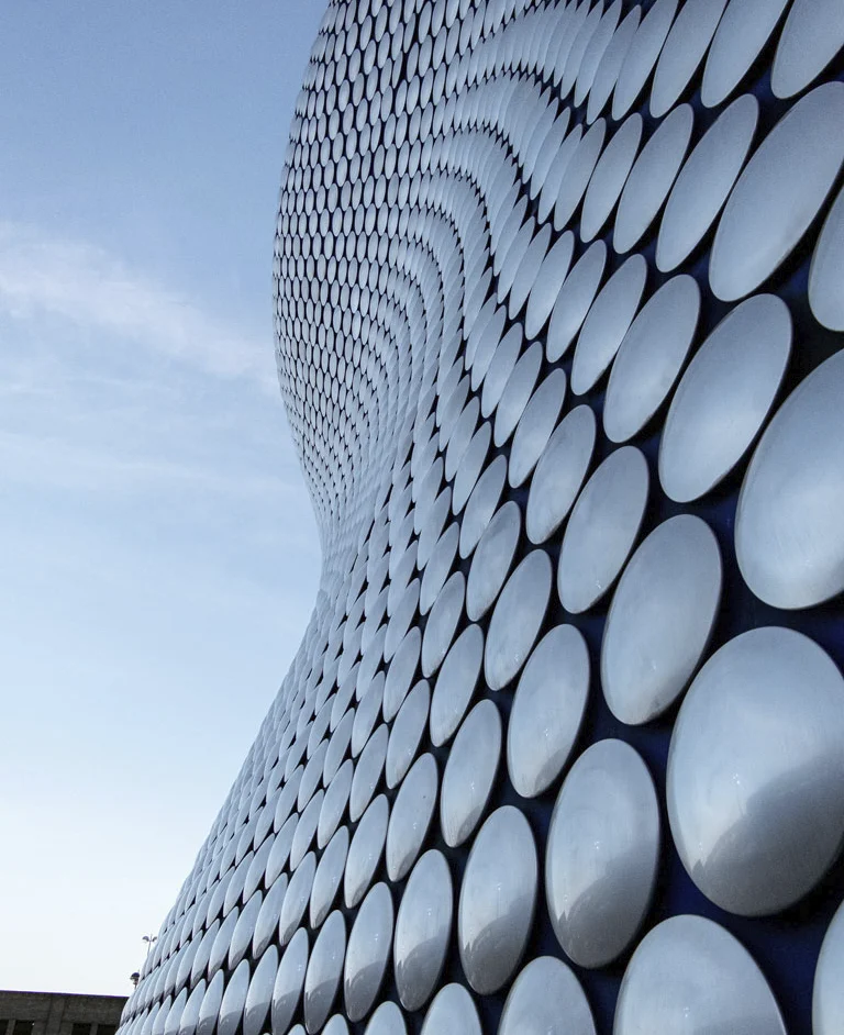 Modern building facade with circular metallic panels