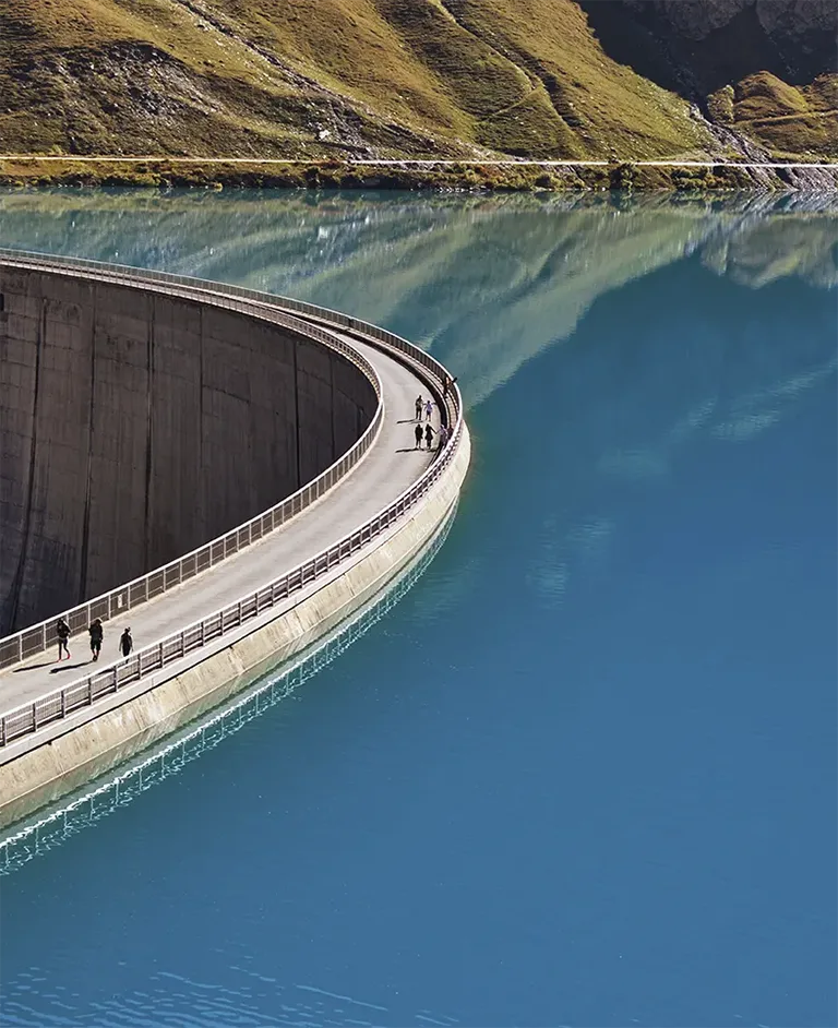 Curved dam surrounded by a mountain reservoir