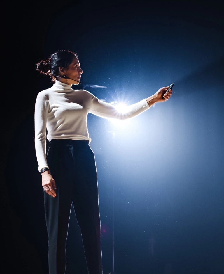 Woman delivering a presentation on stage
